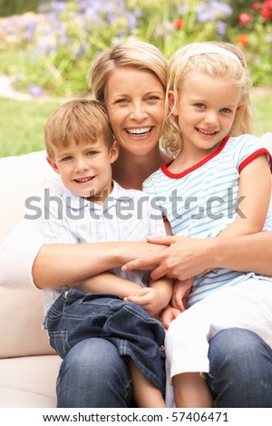 Mother And Children Relaxing In Garden