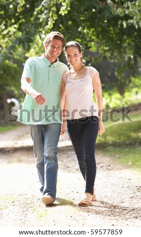 Affectionate Couple Walking In Countryside Together