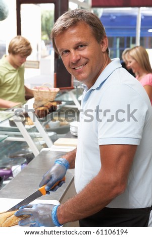 Man Working Behind Counter In Cafe