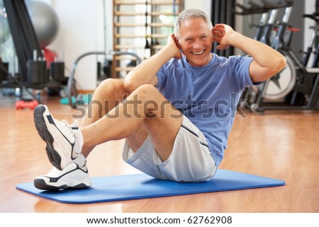 Senior Man Doing Sit Ups In Gym Senior Man Doing Sit Ups In Gym