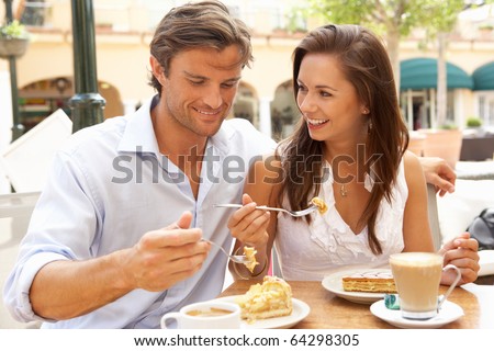 stock-photo-young-couple-enjoying-coffee-and-cake-in-cafe-64298305