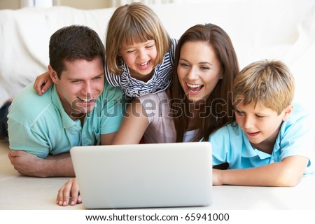 Young parents, with children, on laptop computer