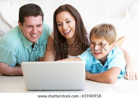 Young parents, with child, on laptop computer