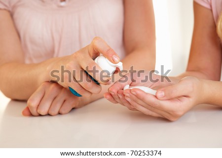 Woman hand applying hand sanitizer