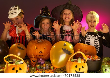 Halloween party with children wearing fancy costumes
