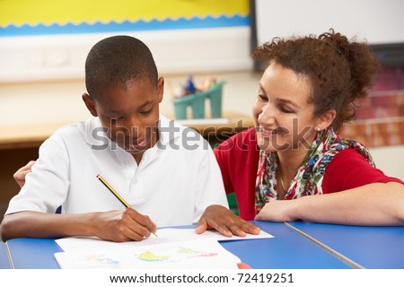 Schoolboy Studying In Classroom With Teacher Schoolboy Studying In Classroom With Teacher