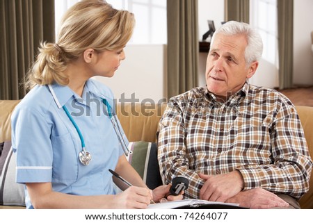 Senior Man Talking To Health Visitor At Home