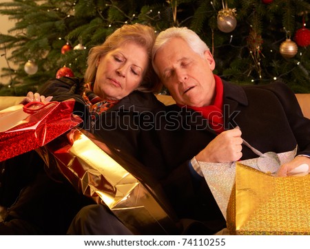 Tired Senior Couple Returning After Christmas Shopping Trip