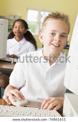 Student at computer terminal with student in background