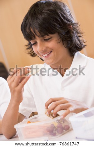 Student in cafeteria eating lunch