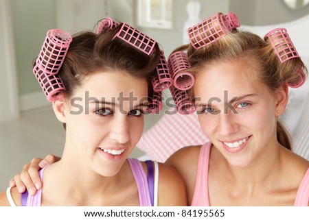 Teenage girls with hair in curlers