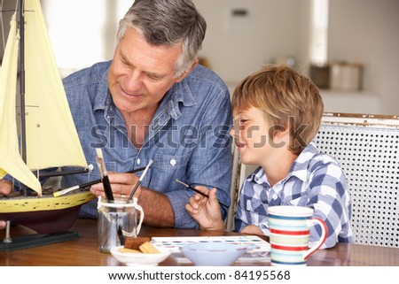 Senior man model making with grandson