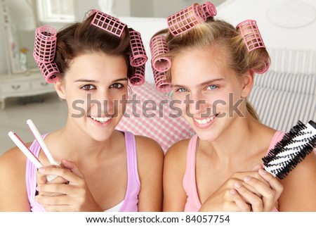 Teenage girls with hair in curlers