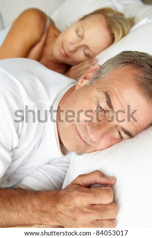 Head and shoulders mid age couple sleeping