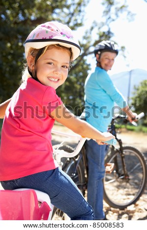 Little girl on country bike ride with grandma