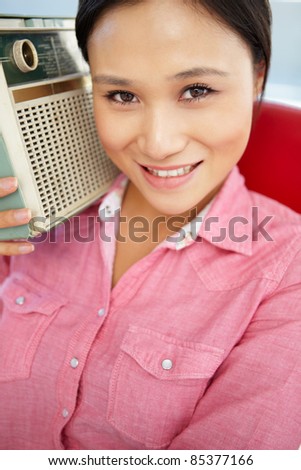 Young woman listening to radio