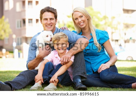 Couple in city park with young son and dog