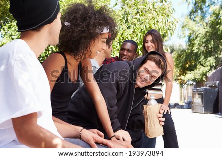 Gang Of Young People In Urban Setting Drinking Alcohol