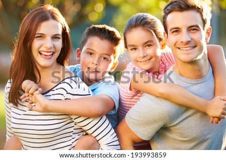 Outdoor Portrait Of Family Having Fun In Park