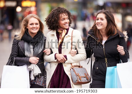 Three Female Friends Shopping Outdoors Together