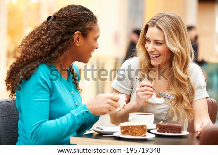 Two Female Friends Meeting In Cafe