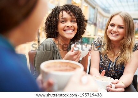Group Of Young Female Friends Meeting In Cafe