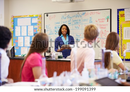 Teacher And Pupils In High School Science Class