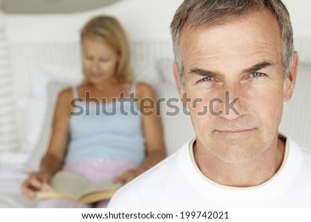Mid age couple in bedroom