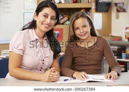 Teacher and schoolgirl in class
