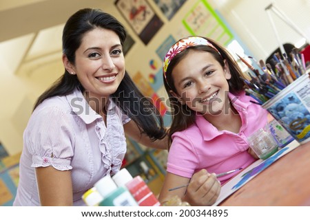 Teacher and pupil in art class