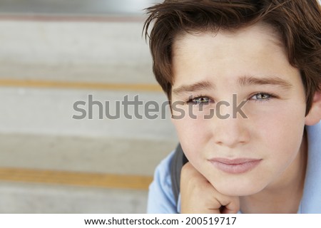 Unhappy Pre teen boy at school Unhappy Pre teen boy at school