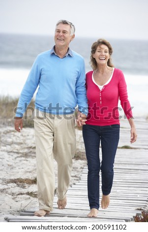 Senior couple walking by the sea