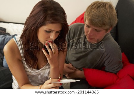 Teenage couple with pregnancy test