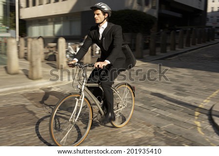 Businessman cycling to work
