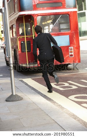 Businessman running for bus
