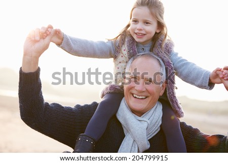 Grandfather And Granddaughter Walking On Winter Beach Grandfather And Granddaughter Walking On Winter Beach