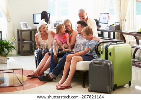 Multi Generation Family Arriving In Hotel Lobby