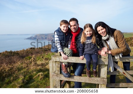 Portrait Of Family Walking Along Coastal Path