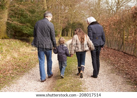 Grandparents With Grandchildren On Walk In Countryside