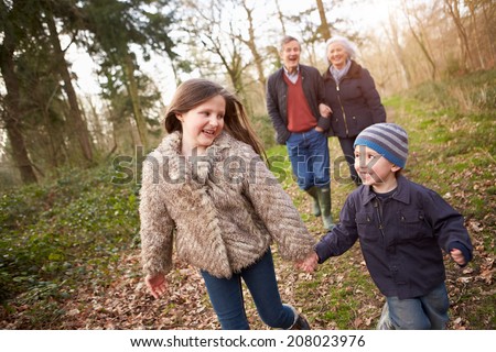 Grandparents With Grandchildren On Walk In Countryside