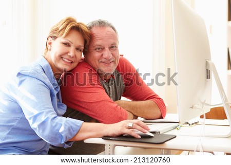 Senior Couple Using Computer At Home