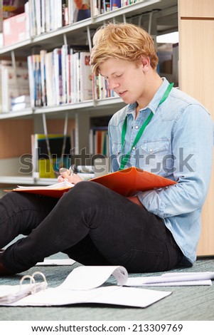 Male College Student Studying In Library