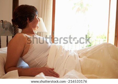 Woman Waking Up In Bed In Morning