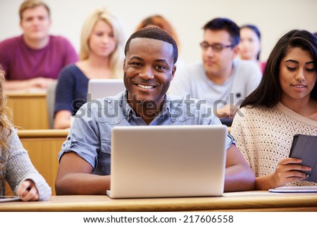 Male University Student Using Laptop In Lecture