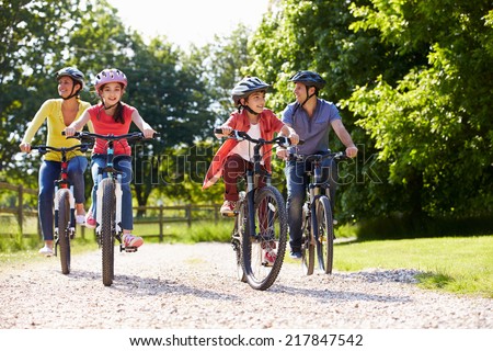 Hispanic Family On Cycle Ride In Countryside
