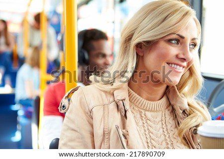 Woman Enjoying Takeaway Drink On Bus Journey