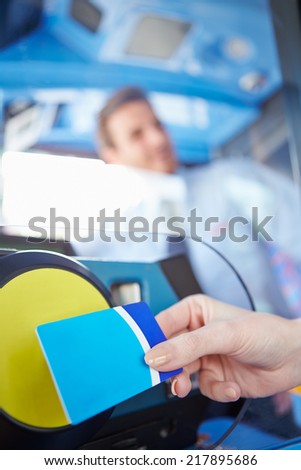 Close Up Of Hand Using Bus Pass For Journey