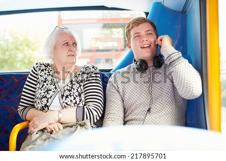 Man Disturbing Passengers On Bus Journey With Phone Call
