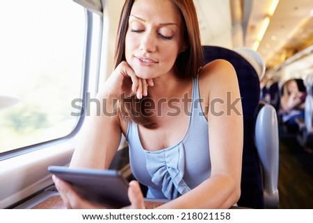Woman Reading E Book On Train