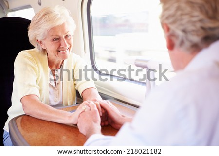 Senior Couple Relaxing On Train Journey